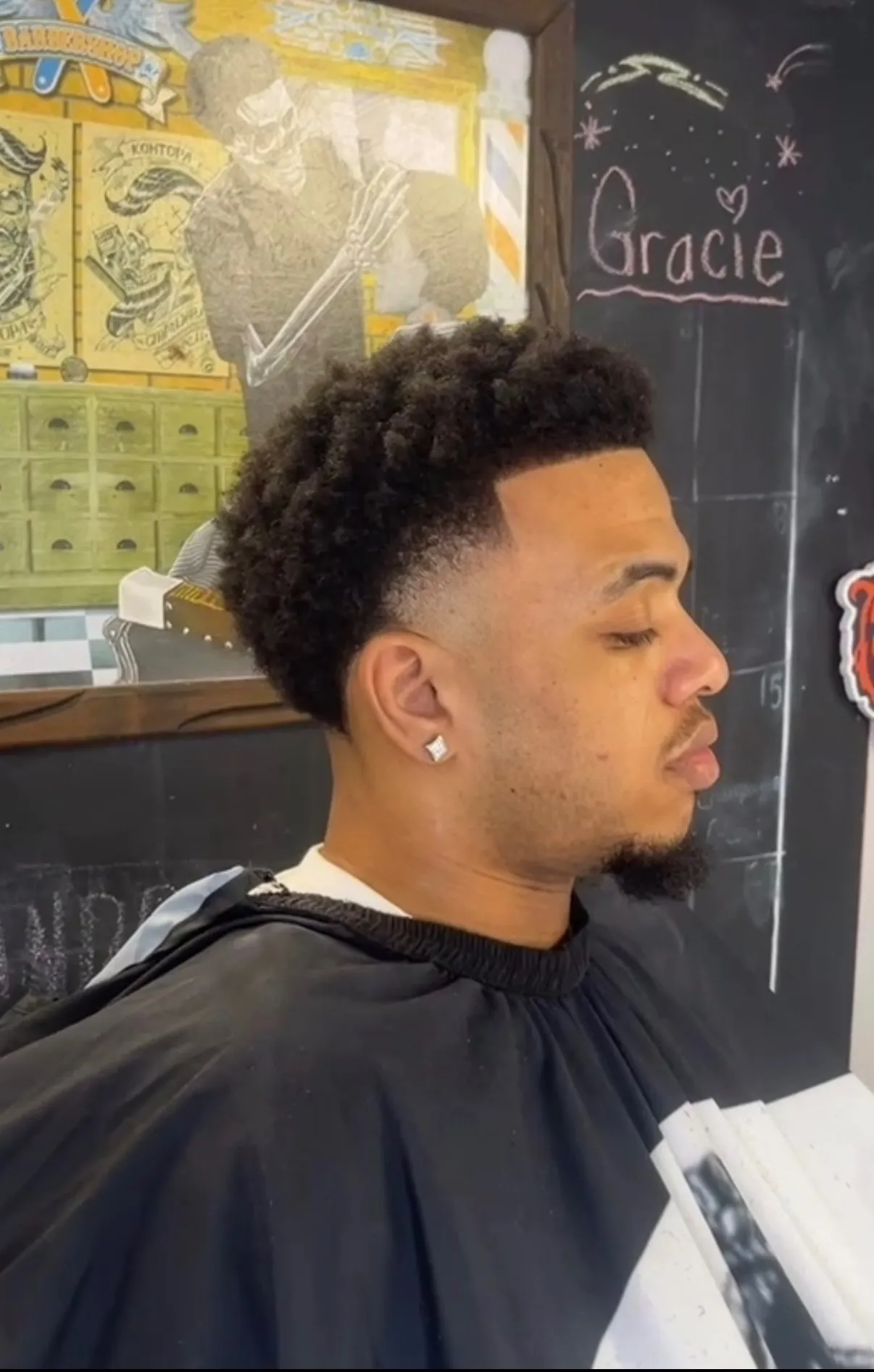 Curly top with a clean taper fade and sharp lineup